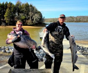 Man and woman holding their catches