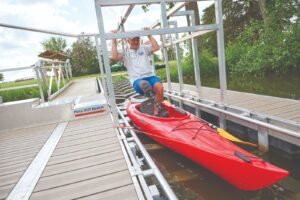 Man entering kayak from BoardSafe adaptive kayak launch