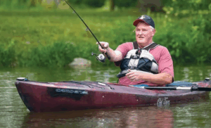 Man fishing in kayak on Lake Loramie