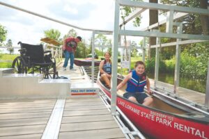 Mother and child in rental canoe at BoardSafe adaptive kayak launch
