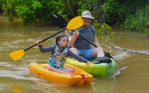 Father and young son in paddleboats