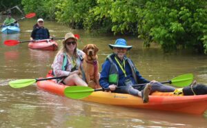 Man, woman and dog in paddleboat