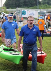 Men carrying paddleboats