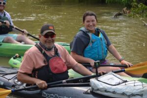 Smiling man and woman in paddleboat