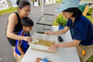 Upstream Alliance mother and son sampling food vendor