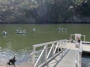 Adaptive kayakers on water around BoardSafe launch