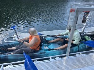 man and woman in kayak exiting launch