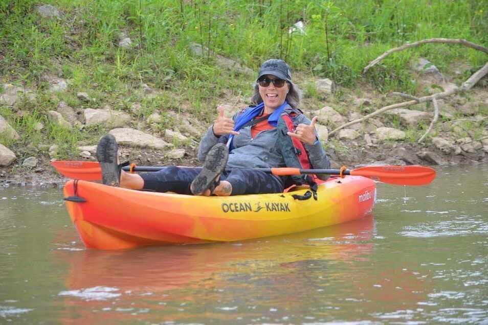 woman in kayak giving thumbs up