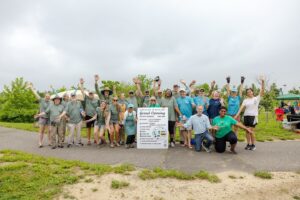 Upstream Alliance workers with grand opening sign