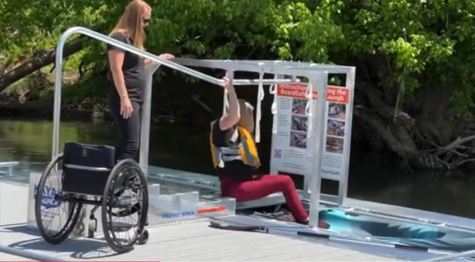 Woman entering kayak from BoardSafe accessible launch
