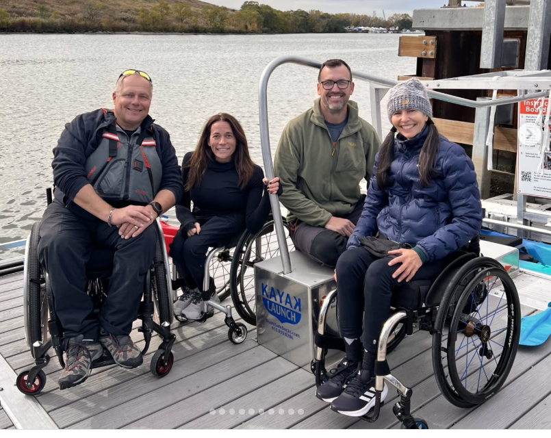 Patrons in wheelchairs sitting on BoardSafe adaptive kayak launch